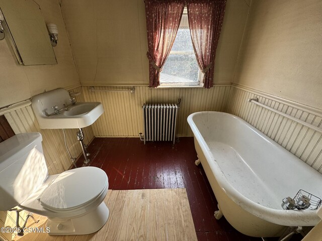 127 N 3rd St, Lewisburg, PA 17837 - full bathroom featuring radiator, a freestanding tub, wainscoting, toilet, and hardwood / wood-style floors