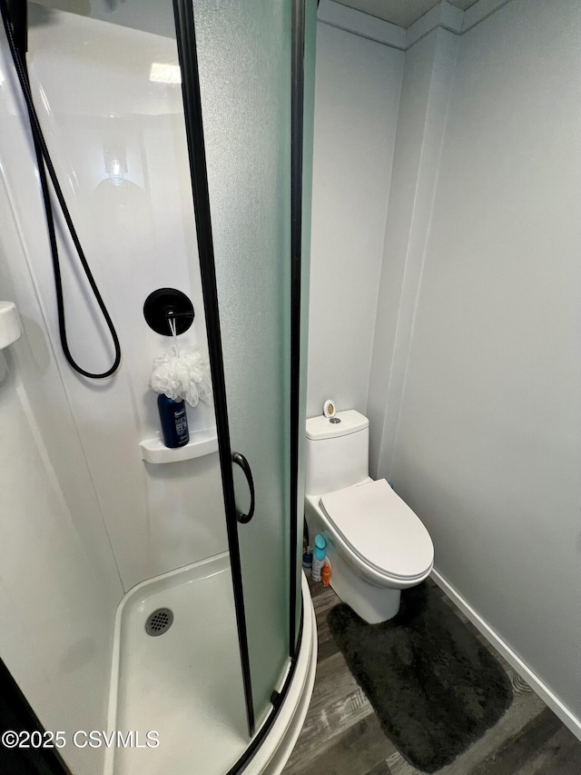 511 Snowflake Ln, Shickshinny, PA 18655 - bathroom featuring a shower stall, wood finished floors, toilet, and baseboards