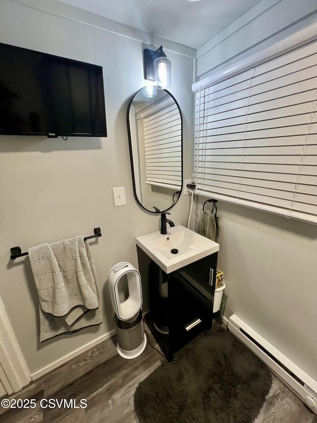 511 Snowflake Ln, Shickshinny, PA 18655 - bathroom featuring a baseboard heating unit, wood finished floors, vanity, and baseboards