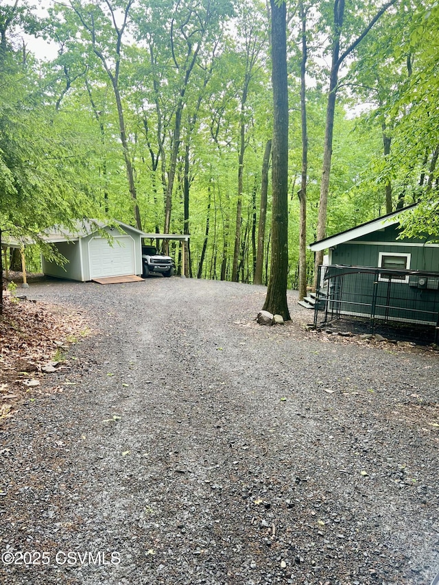 511 Snowflake Ln, Shickshinny, PA 18655 - view of yard with gravel driveway, an attached garage, an outbuilding, and a carport