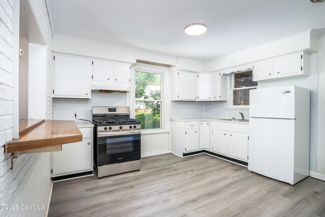1355 Salem Blvd, Berwick, PA 18603 - kitchen with freestanding refrigerator, gas stove, a sink, light countertops, and light wood-style floors