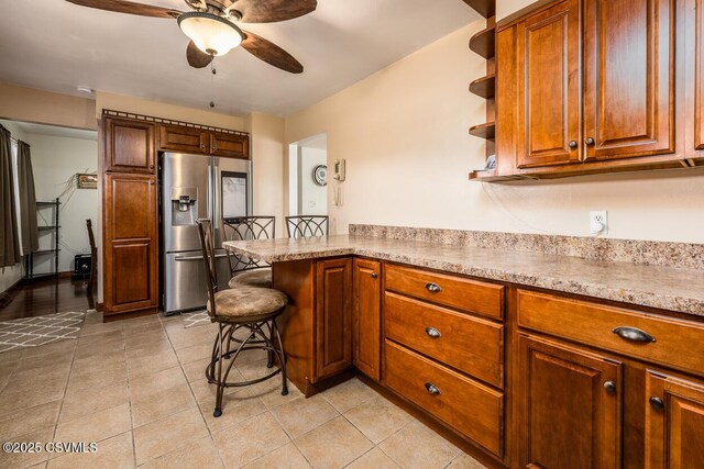 306 Clybourne Ave, Berwick, PA 18603 - kitchen featuring stainless steel refrigerator with ice dispenser, a peninsula, a ceiling fan, open shelves, and brown cabinetry