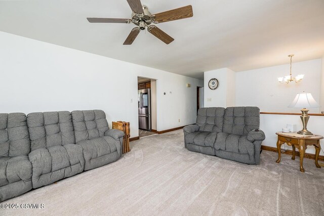 306 Clybourne Ave, Berwick, PA 18603 - living area with carpet, a ceiling fan, a chandelier, and baseboards
