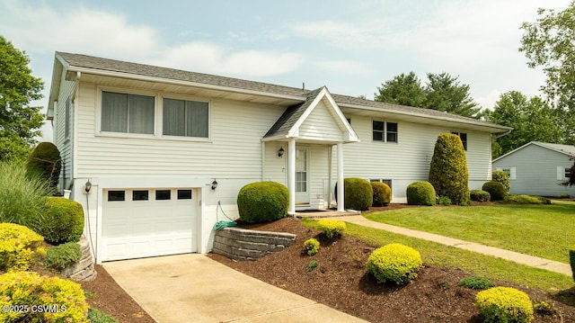 306 Clybourne Ave, Berwick, PA 18603 - bi-level home featuring an attached garage, driveway, and a front lawn