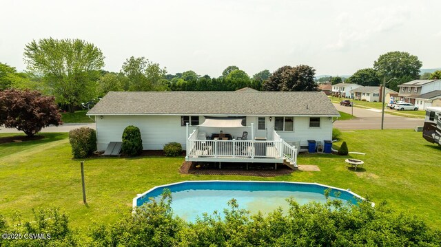 306 Clybourne Ave, Berwick, PA 18603 - back of property with a deck, a lawn, an outdoor fire pit, and an outdoor pool