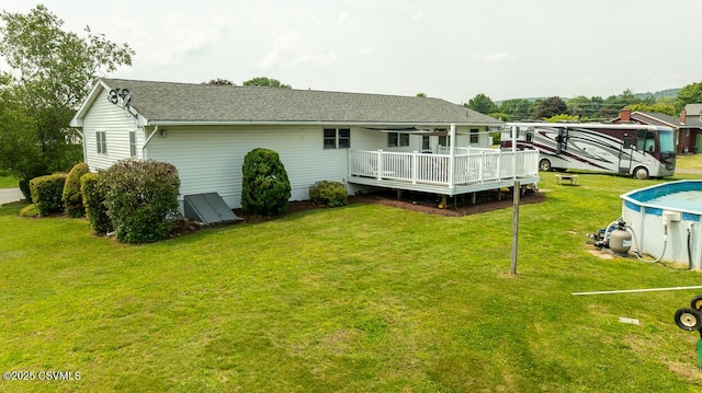 306 Clybourne Ave, Berwick, PA 18603 - back of house with a deck, a yard, roof with shingles, and an outdoor pool