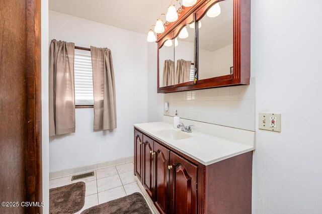 306 Clybourne Ave, Berwick, PA 18603 - bathroom featuring vanity, decorative backsplash, and tile patterned floors