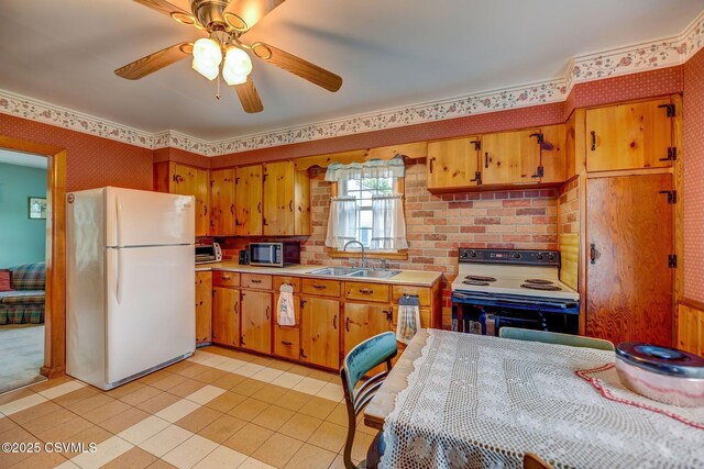 333 Bissets Ln, Bloomsburg, PA 17815 - kitchen with freestanding refrigerator, a sink, electric stove, stainless steel microwave, and light countertops