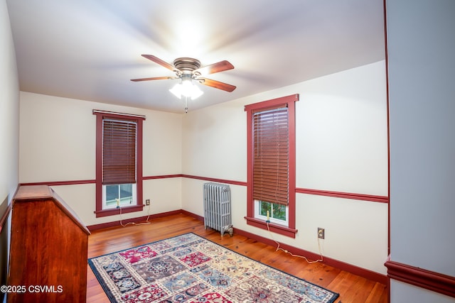 637 Pfahler St, Catawissa, PA 17820 - empty room featuring radiator, a ceiling fan, and wood finished floors