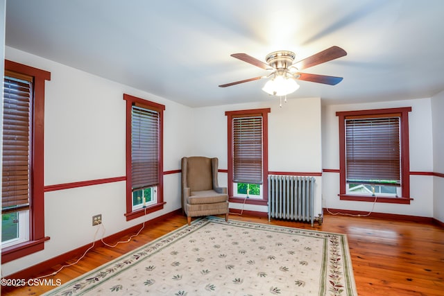 637 Pfahler St, Catawissa, PA 17820 - living area featuring radiator heating unit, wood finished floors, ceiling fan, and healthy amount of natural light