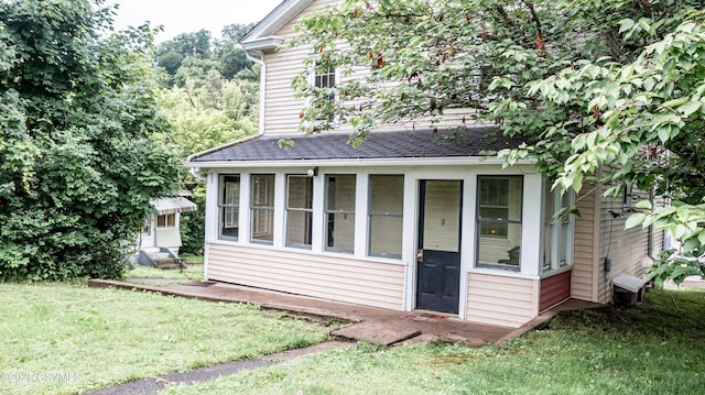 637 Pfahler St, Catawissa, PA 17820 - view of front of property featuring a shingled roof, a front yard, entry steps, and a sunroom