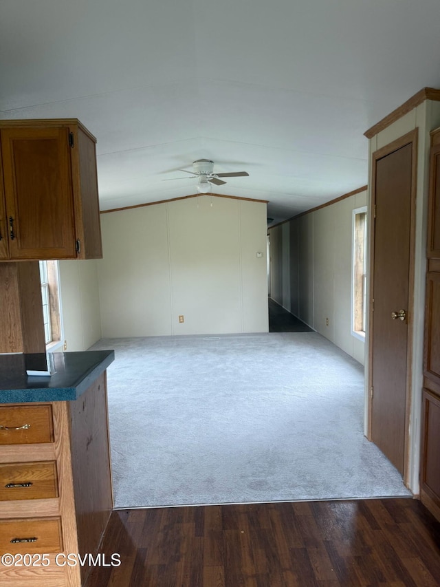 2638 Melanie Rd, Ringtown, PA 17967 - unfurnished living room with ceiling fan, dark carpet, crown molding, healthy amount of natural light, and dark wood-style floors
