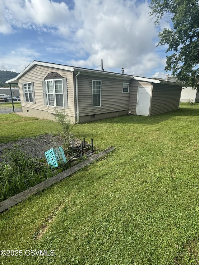 1311 Water St, Northumberland, PA 17857 - rear view of house with crawl space, a yard, and a storage shed