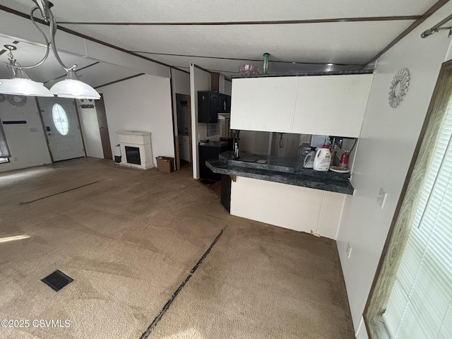 1311 Water St, Northumberland, PA 17857 - kitchen with white cabinetry, carpet, and dark countertops