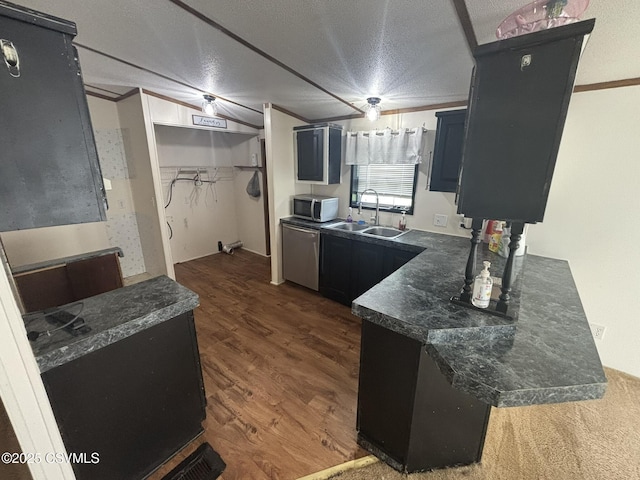1311 Water St, Northumberland, PA 17857 - kitchen featuring appliances with stainless steel finishes, dark countertops, dark wood-style floors, a textured ceiling, and dark cabinets