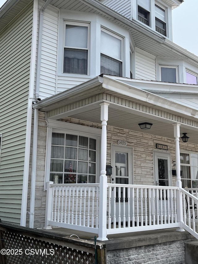1409 Scott St, Kulpmont, PA 17834 - view of exterior entry featuring stone siding and covered porch