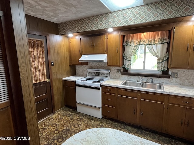 1409 Scott St, Kulpmont, PA 17834 - kitchen featuring white range with electric stovetop, under cabinet range hood, a sink, light countertops, and tasteful backsplash