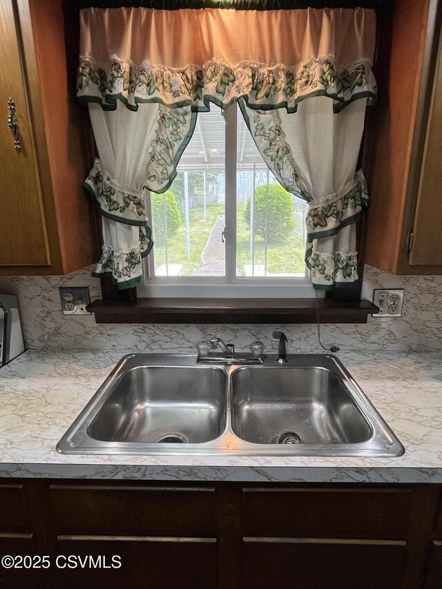 1409 Scott St, Kulpmont, PA 17834 - kitchen with light countertops, a sink, and decorative backsplash