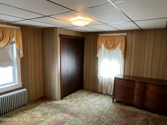 1409 Scott St, Kulpmont, PA 17834 - unfurnished bedroom featuring radiator, a closet, carpet flooring, and wooden walls