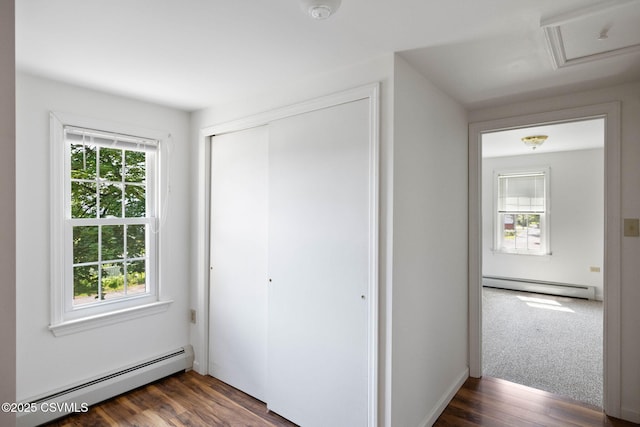 110 W 8th St, Watsontown, PA 17777 - unfurnished bedroom with a baseboard heating unit, dark wood-type flooring, attic access, and a closet