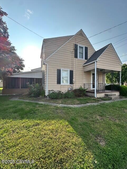1030 Orange St, Berwick, PA 18603 - view of front of house featuring a front lawn and covered porch