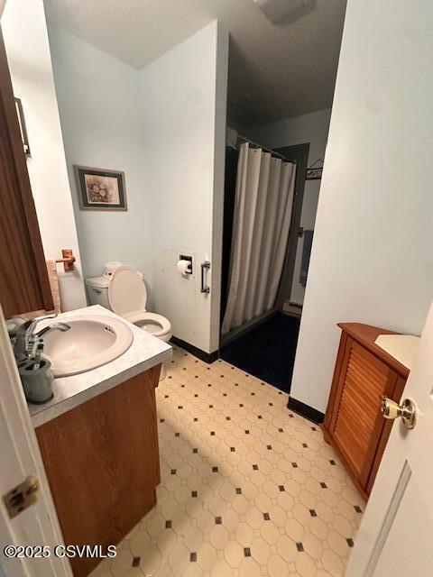 1030 Orange St, Berwick, PA 18603 - full bath with vanity, tile patterned floors, a shower with shower curtain, and a baseboard radiator