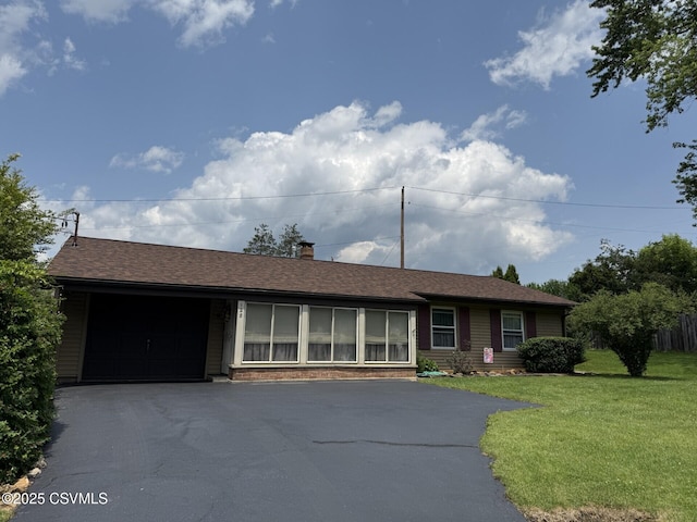 128 Woodside Rd, Sunbury, PA 17801 - ranch-style house featuring driveway, a garage, a front lawn, and a chimney