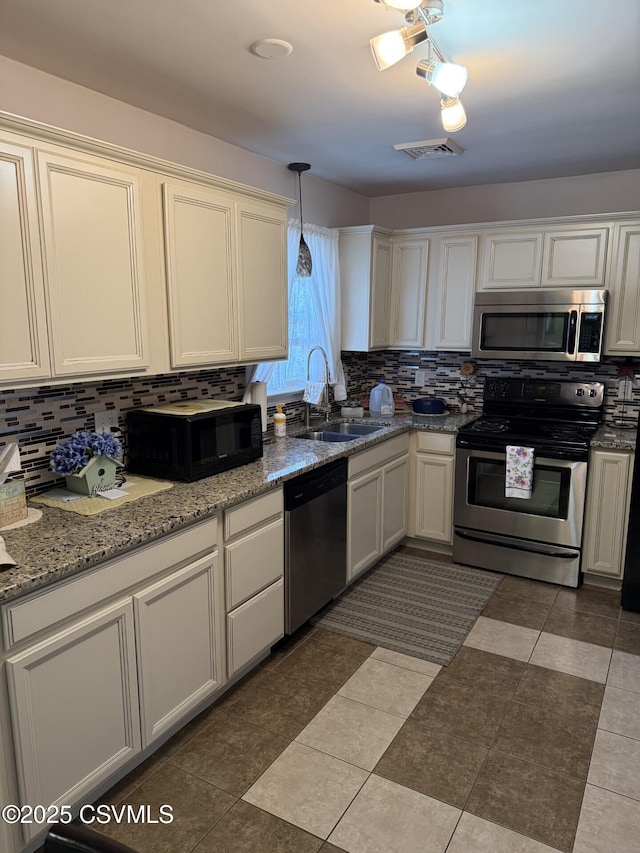 128 Woodside Rd, Sunbury, PA 17801 - kitchen with appliances with stainless steel finishes, tasteful backsplash, and white cabinets