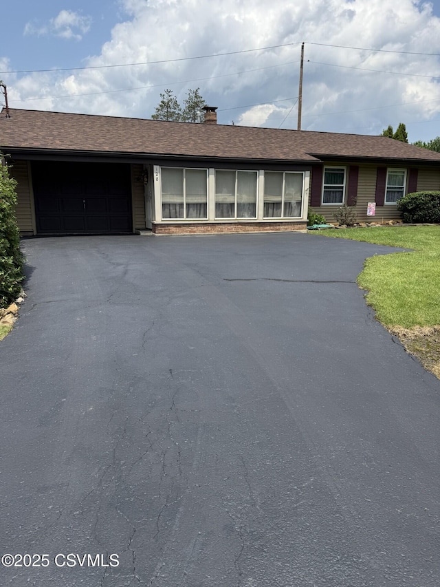 128 Woodside Rd, Sunbury, PA 17801 - single story home featuring driveway, an attached garage, and a chimney