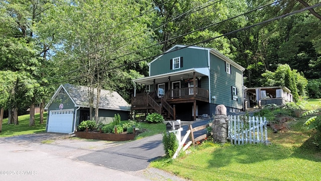 124 E Coal St, Trevorton, PA 17881 - view of front of house featuring an outbuilding, stairs, a porch, a front lawn, and a garage