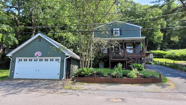 124 E Coal St, Trevorton, PA 17881 - view of front of house featuring a porch, stairway, a garage, and asphalt driveway