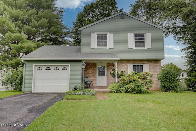 7 N Red Maple St, Selinsgrove, PA 17870 - view of front of home with an attached garage, driveway, brick siding, a front yard, and a shingled roof