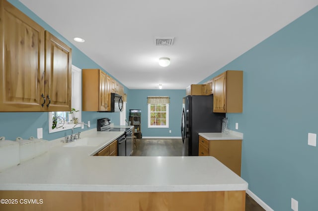 152 Bridge Ave, Allenwood, PA 17810 - kitchen featuring range with electric stovetop, light countertops, freestanding refrigerator, and dark wood-type flooring