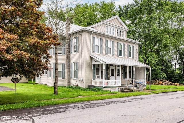109 W Ninth St, Watsontown, PA 17777 - view of front of house with covered porch, a chimney, and a front lawn