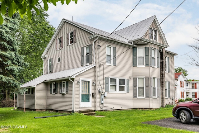 109 W Ninth St, Watsontown, PA 17777 - view of property exterior featuring a yard, a metal roof, and entry steps