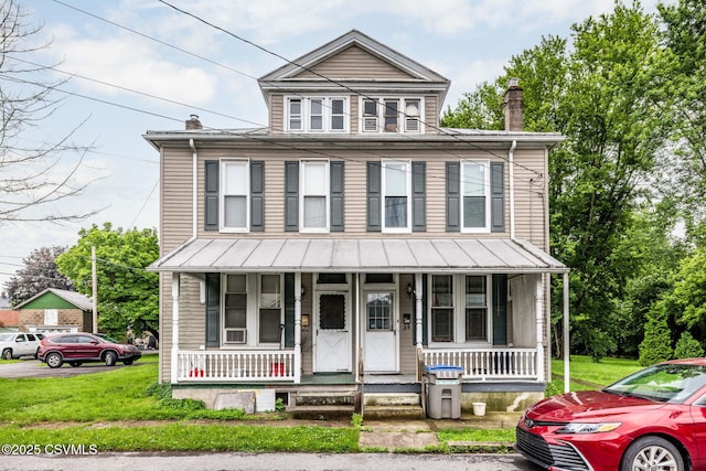 109 W Ninth St, Watsontown, PA 17777 - view of front of property with a porch, a chimney, and a front lawn