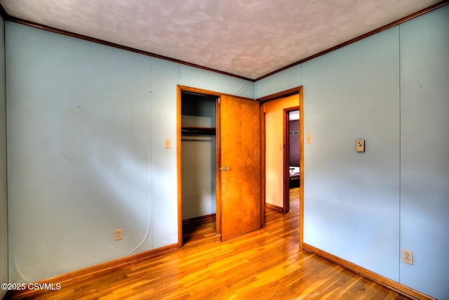 157 Distillery Hill Rd, Benton, PA 17814 - unfurnished bedroom with wood finished floors, crown molding, and a closet