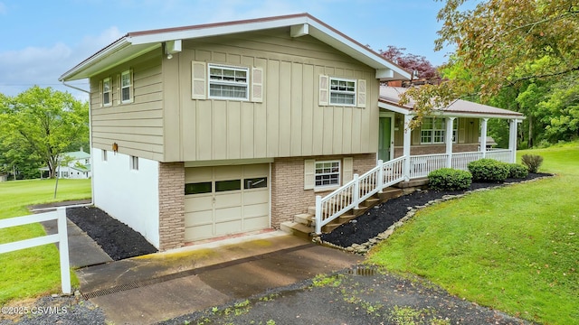 157 Distillery Hill Rd, Benton, PA 17814 - tri-level home featuring a garage, board and batten siding, covered porch, a front lawn, and driveway