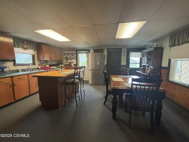 1211 W Mulberry St, Coal Township, PA 17866 - kitchen featuring freestanding refrigerator, dark colored carpet, a drop ceiling, and plenty of natural light