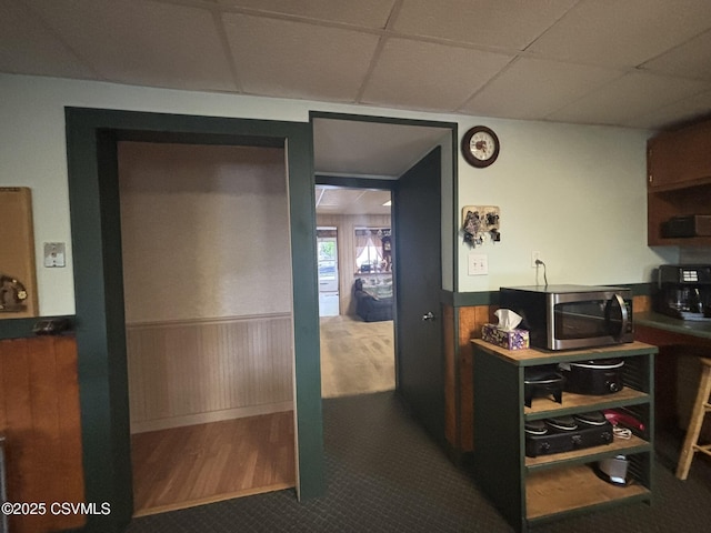 1211 W Mulberry St, Coal Township, PA 17866 - kitchen featuring stainless steel microwave, wainscoting, a paneled ceiling, and wood walls
