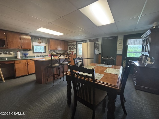 1211 W Mulberry St, Coal Township, PA 17866 - dining room featuring dark colored carpet, a paneled ceiling, and healthy amount of natural light
