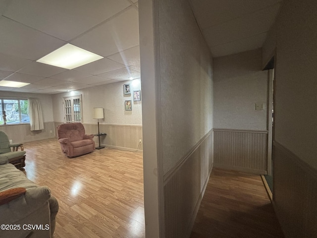 1211 W Mulberry St, Coal Township, PA 17866 - living room featuring wood finished floors, a wainscoted wall, and a paneled ceiling