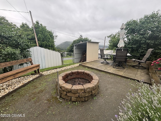 1211 W Mulberry St, Coal Township, PA 17866 - view of patio featuring a fire pit, outdoor dining space, and a storage unit