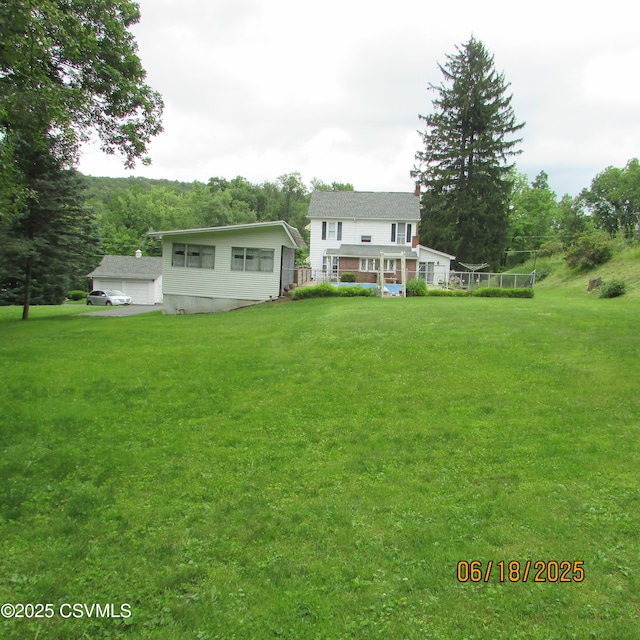 324 Tulip Rd, Paxinos, PA 17860 - rear view of property with a yard, a chimney, and a garage