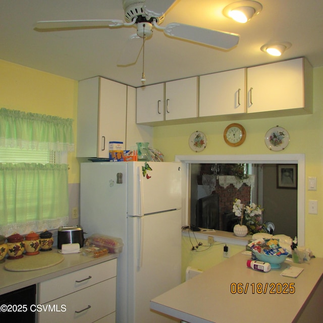 324 Tulip Rd, Paxinos, PA 17860 - kitchen with freestanding refrigerator, light countertops, white cabinetry, and a ceiling fan