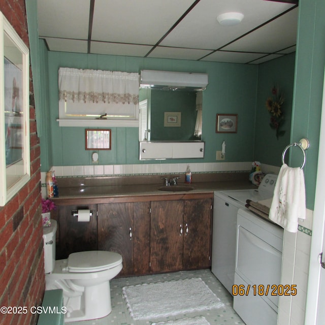 324 Tulip Rd, Paxinos, PA 17860 - half bath featuring washer and dryer, vanity, and a paneled ceiling