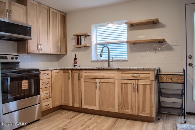 107 17th St, Coal Township, PA 17866 - kitchen featuring appliances with stainless steel finishes, open shelves, and light wood-style flooring