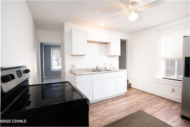 126-128 Murray Ave, Bloomsburg, PA 17815 - kitchen with electric range, white cabinets, light wood-style flooring, and a ceiling fan