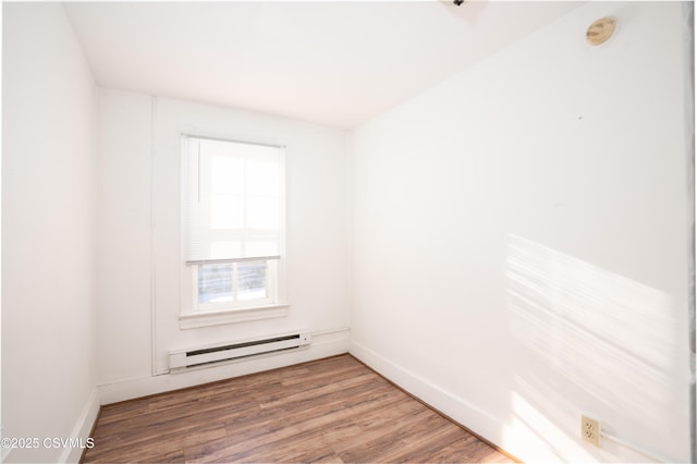 126-128 Murray Ave, Bloomsburg, PA 17815 - empty room featuring baseboard heating, a smoke detector, and wood finished floors