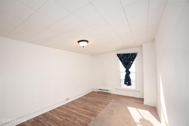 126-128 Murray Ave, Bloomsburg, PA 17815 - empty room with wood finished floors and a baseboard heating unit